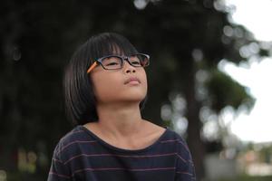 Portrait of child wearing eyeglasses with blur background photo