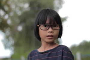 Portrait of child wearing eyeglasses with blur background. photo