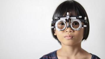 Kid eye test, girl wearing glasses photo