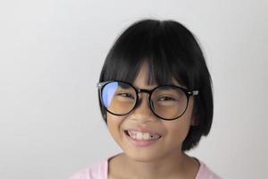 Portrait of child wearing eyeglasses on white background photo