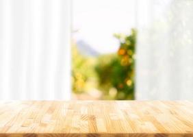 Empty of wood table  on blur abstract garden with sunlight and curtain window , product display, Ready for product montage. photo