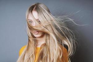 mujer rubia con el pelo largo y despeinado azotado por el viento foto