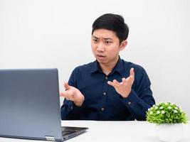 Man gesture explain his work online with laptop on the table white background photo