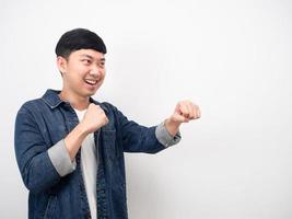 Asian man jean shirt gesture punch at copy space photo