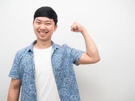 Cheerful asian man happy smile show muscle arm healthy concept photo