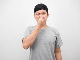 Man feeling smelly close his nose portrait white background photo