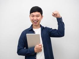 Man happy emotion holding tablet show fist up,Success man concept photo