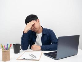 Male employee sitting at office workplace feel headache,laptop on table photo