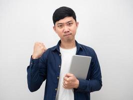 Asian man holding tablet and show fist up gesture confident face photo