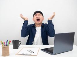 Male employee sitting at office workplace feel mad about working photo