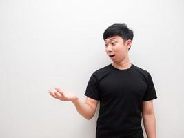Asian man look at right hand up with happy smile and wow on white background space