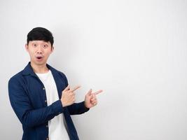 Handsome man point double finger right side with happy smile looking at camera on white isolated background photo