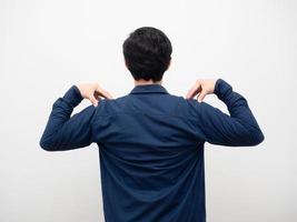 Man standing turn back and touch his shoulder white background photo