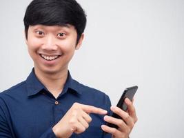 Asian man happy face smiling point at mobile phone in hand for shopping photo