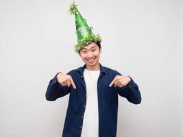 Cheerful man wearing green hat happy smile point finger down copy space photo