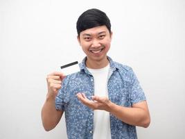 Man blue shirt showing credit card in hand smiling happy photo