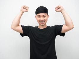 Asian man show fist up for success confident face photo