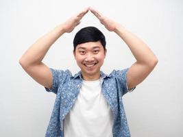 Cheerful asian man smiling gesture hand roof house portrait photo