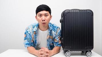 Man blue shirt with luggage excited emotion with holiday photo
