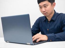 Man sitting at office workplace using laptop for working photo