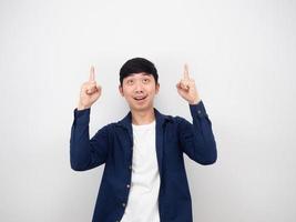Asian man pointfinger and looking up at copy space on white background photo