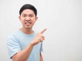 Man angry face looking and point finger at copy space white background photo