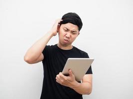 Man checking data with tablet and feeling bored and sad emotion photo