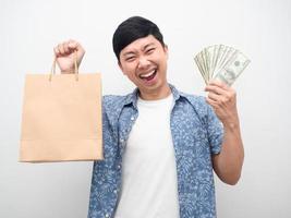 Man happiness with shopping,Cheerful man holding a lot of money and shopping bag photo