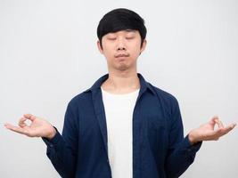 Portrait asian man close his eyes gesture yoga make meditate to do work photo