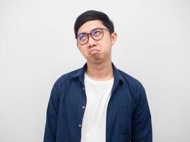 Asian man wearing glasses feeling bored looking up on space white background