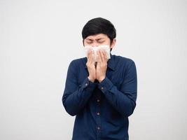 Asian man sick feeling unwell cough and close his face by tissue paper white background photo