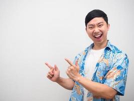 Cheerful man holiday shirt point finger at copy space delighted emotion photo