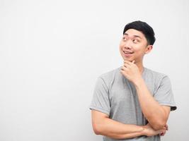 Asian man gesture thinking and looking at copy space photo