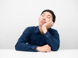 Asian man sitting sleep at the table white background photo