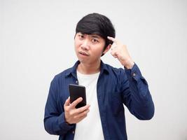 Man holding mobile phone feeling serious point finger at his head for thinking photo