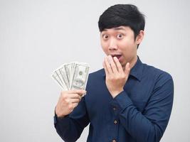 Asian man show money in his hand feel amazed say wow on white background photo