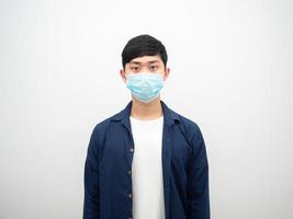 Asian man with protect mask standing and looking at camera on isolated white photo