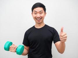 Man holding drumbbell with happy smile thumb up motivation workout concept photo