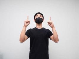 Asian man weraing mask point double finger and look up on white background photo