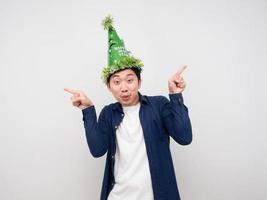 Man wearing green hat gesture funny dance with new year celebration concept photo