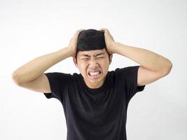 Asian man very headache touch head two hand sad at face black shirt on white isolate background portrait photo