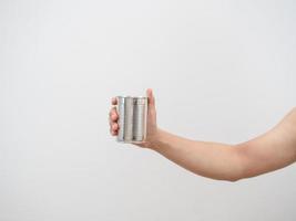 Man hand holding metal can empty on white isolated backgroud photo