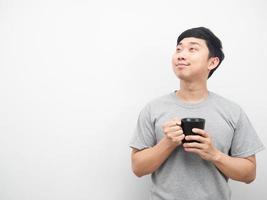 Man holding coffee cup gesture dreaming and looking at copy space photo