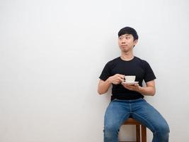 Asian man holding coffee cup in hand feel relax and happy face looking at space on white background photo