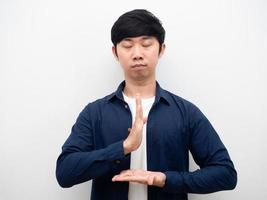 Young man standing hand respect close his eyes for meditate portrait white background photo