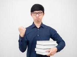 Asian man wearing glasses confident show fist up and holding book in hand portrait white background photo