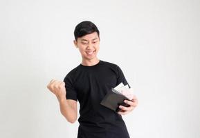 Young Asian man black shirt show fist up and happy face with money in wallet in hand on white isolated background