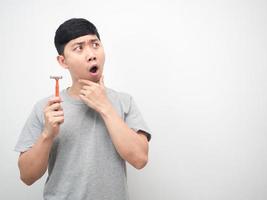 Man holding shaving gesture wow and ecxited looking at copy space photo