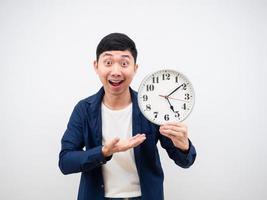 Asian man show clock in his hand happy face get off work concept on white background photo