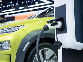 Electric charging vehicle plug for recharge battery of car clean energy power for future concept photo